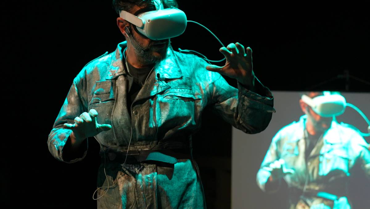 Actor with VR headset in theatrical setting